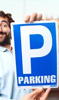 Happy man showing off a parking sign representing efficient parking management