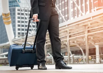 Business traveler with luggage ready to embark on a corporate journey.