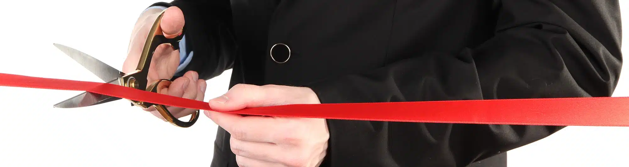 Mans hand cutting red ribbon 2 - moveinsync