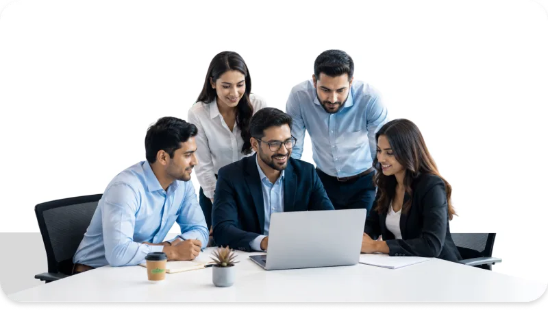Employees collaborating in a meeting and reviewing plans on a laptop